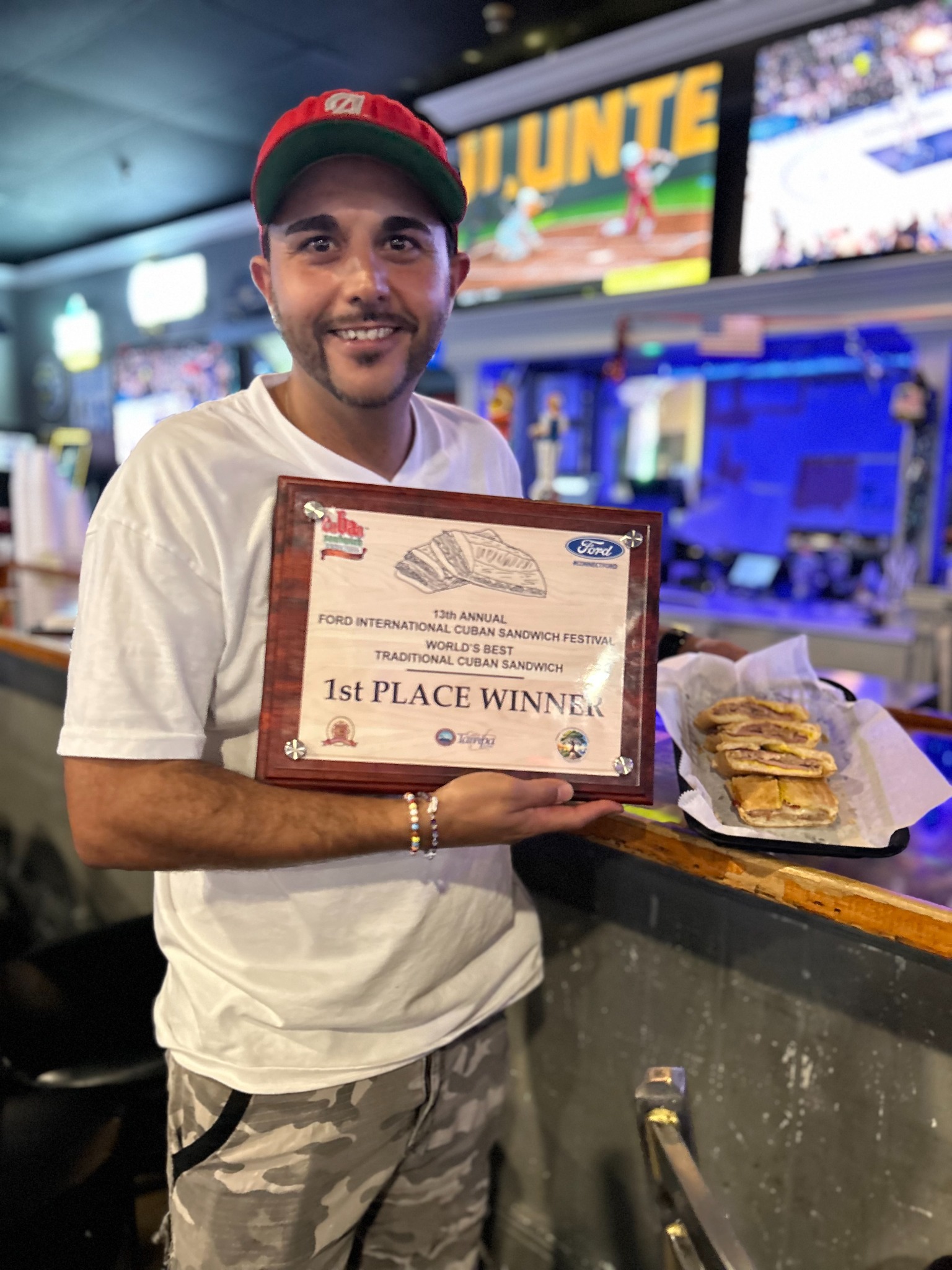 Chef Alex Planchart with the first-place World's Best Traditional Cuban Sandwich award and the winning sandwich
