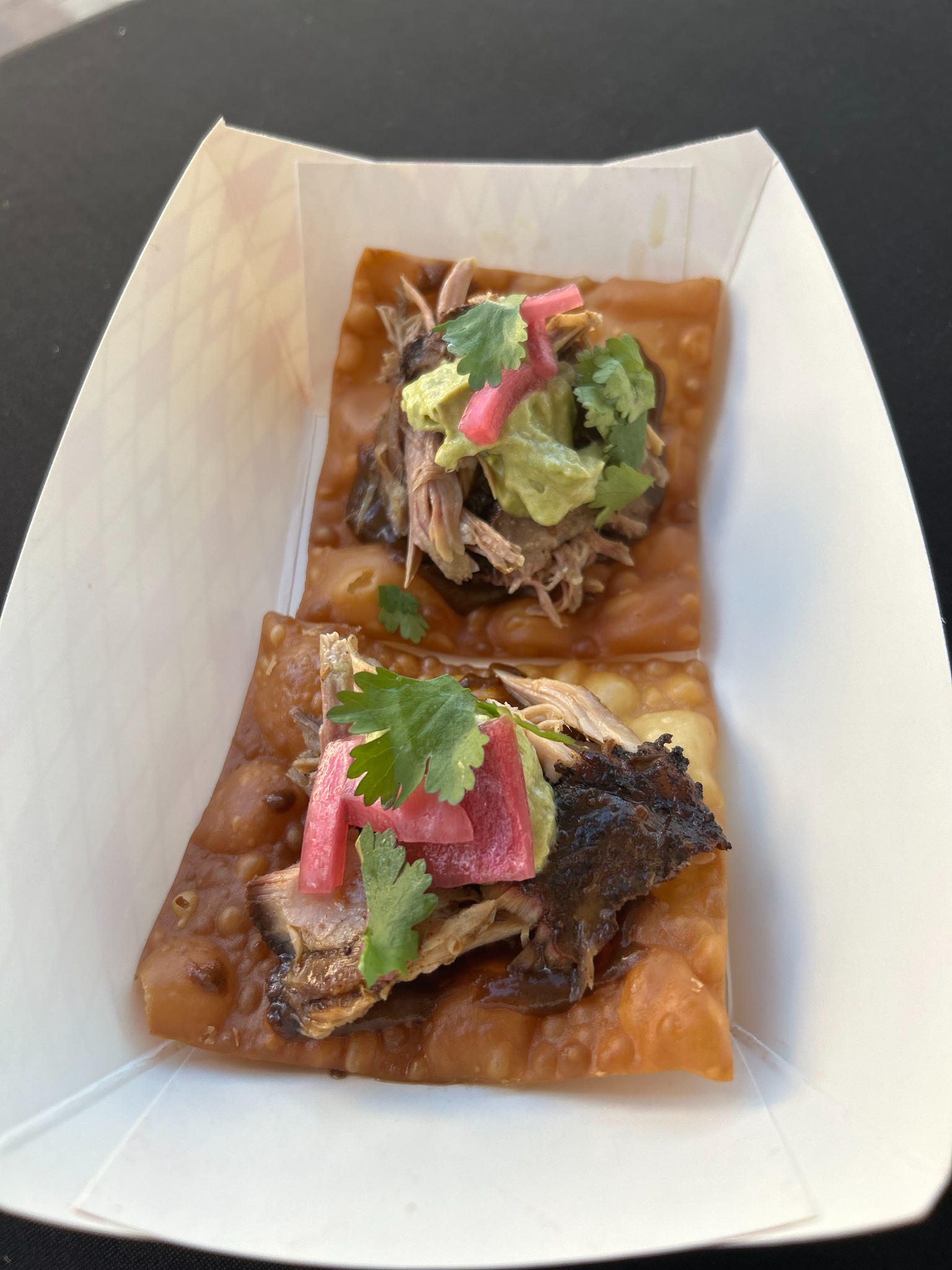 Crisp tostadas topped with pork guacamole and pickled onion