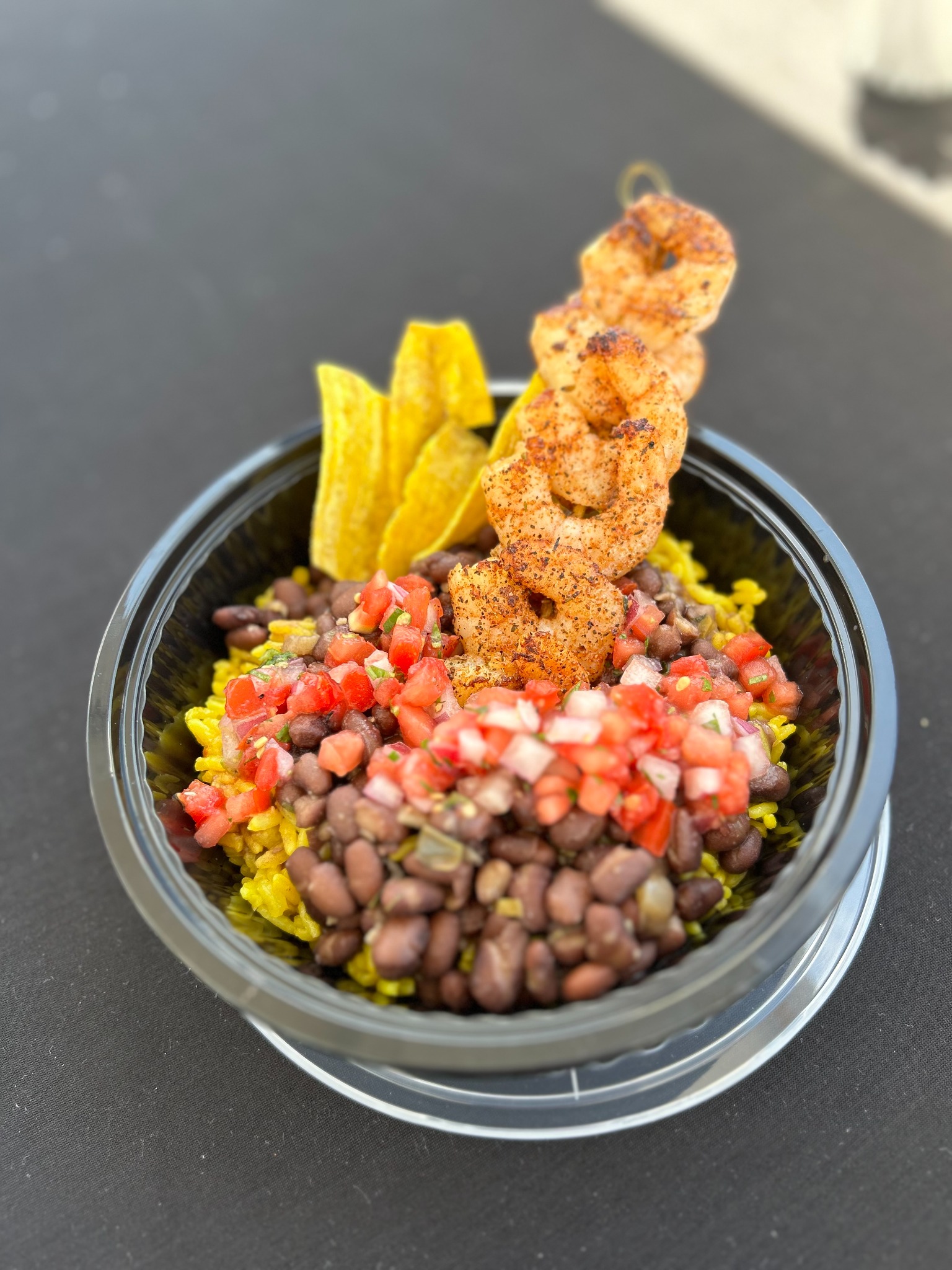 Seasoned shrimp bowl with yellow rice beans and pico de gallo